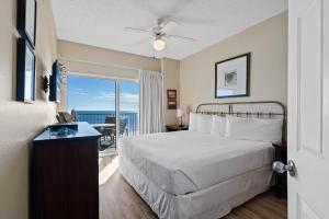 a bedroom with a bed and a view of the ocean at Tidewater Unit 801 in Orange Beach