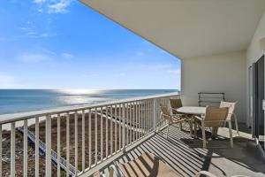 a balcony with a table and chairs and the ocean at Tidewater Unit 801 in Orange Beach