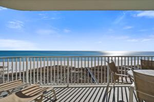 a balcony with chairs and a view of the beach at Tidewater Unit 801 in Orange Beach