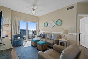 a living room with a couch and a balcony at Tidewater Unit 801 in Orange Beach +43 photos