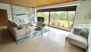 a living room with a couch and a tv at Group Villa EMG Münster Riesenbeck Osnabruck - Saerbeck in Saerbeck