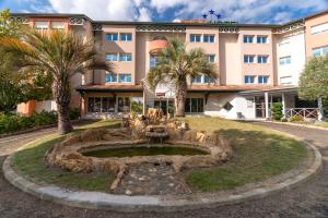 a fountain in front of a building at Abor Hôtel, Mont de Marsan in Saint-Pierre-du-Mont
