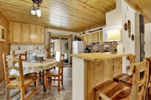 a kitchen and dining room with a table and chairs at Reality Escape by Big Bear Vacations in Big Bear City +16 photos