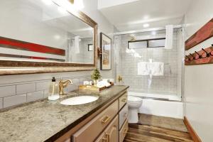 a bathroom with a sink and a toilet at Serenity Cove Lake House by Big Bear Vacations in Big Bear Lake +37 photos