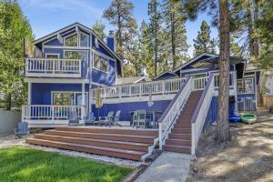 a large blue house with a deck and stairs at Serenity Cove Lake House by Big Bear Vacations in Big Bear Lake