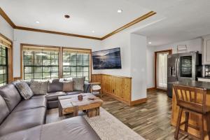 a living room with a couch and a table at Serenity Cove Lake House by Big Bear Vacations in Big Bear Lake