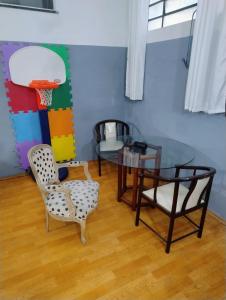 a room with a table and chairs and a basketball hoop at Casa loft Internet 500Mb in Sao Paulo