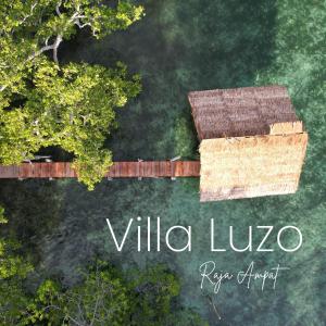 an aerial view of a building with a roof at Villa Luzo & Tours in Saonek