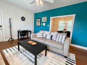 a living room with a couch and a table at Historic & Chic Beaumont Getaway in Beaumont