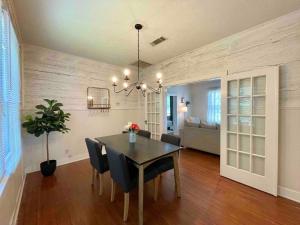 a dining room with a table and chairs and a living room at Historic & Chic Beaumont Getaway in Beaumont