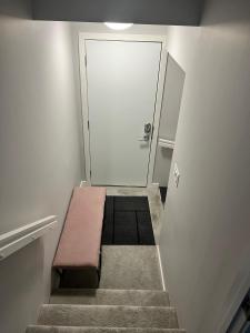 a stairway with a bench in front of a door at Modern Basement Suite with Comforts in Winnipeg