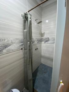 a bathroom with a shower and a toilet in it at Bennyz Guest House in Pretoria +51 photos