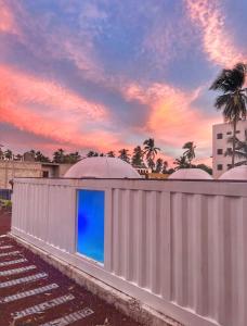 a building with a white fence with a blue window at Casa Garfio in Barra de Navidad +56 photos