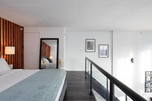 a bedroom with a bed and a balcony at Loft in Entertainment District with FREE underground Parking in Vancouver