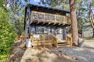 a house with a deck and a tree at Large Bear Lodge by Big Bear Vacations in Sugarloaf