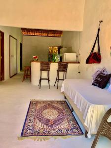 a bedroom with a bed and a table and chairs at Casa Branca in Atins