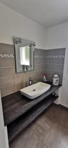 a bathroom with a sink and a mirror at Plain pied idéalement situé in Sainte-Lucie de Porto-Vecchio +5 photos