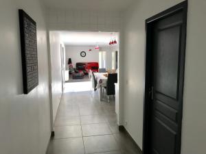 a hallway leading to a dining room and a living room at Plain pied idéalement situé in Sainte-Lucie de Porto-Vecchio