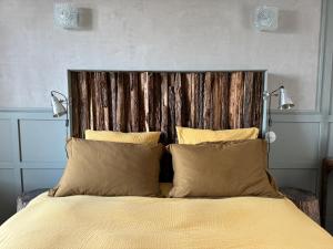 a bedroom with a large bed with two lamps on it at -LA CORDIALITÉ- in Ault