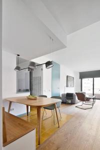 a living room with a table and a dining room at Apartment on Leylek in Baku