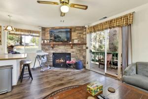 een woonkamer met open haard en een bank bij Green Squirrel Chateau by Big Bear Vacations in Big Bear Lake