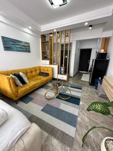 a living room with a couch and a tv at Staycation in Nairobi