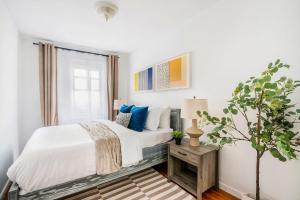 a white bedroom with a bed and a window at 350-1A Gramercy New 1BR Sleeps3 Newly Furnished in New York