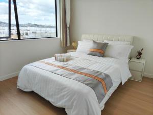 En eller flere senger på et rom på Orewa family holiday house with 3 bed-rooms view on deck near cafe, bush & river