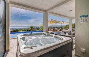 a jacuzzi tub on the patio of a house at Nice Home In Kastel Stari With Jacuzzi in Kastel Stari