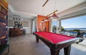 a pool table in a living room with a view at Nice Home In Kastel Stari With Jacuzzi in Kastel Stari