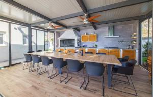 a kitchen with a large wooden table and chairs at Nice Home In Kastel Stari With Jacuzzi in Kastel Stari