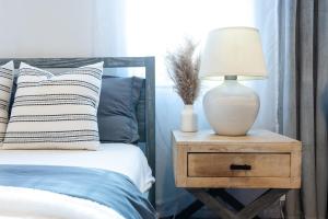 a lamp on a night stand next to a bed at 350-GA Spacious Studio Gramercy Sleeps 3 in New York +26 photos