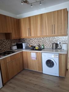 a kitchen with a washer and a washing machine at Apartment with sea view! in Khlorakas +14 photos