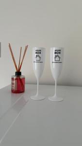 a group of three wine glasses sitting on a table at House Box 05 in Itapema