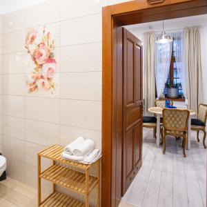 a room with a bathroom with a toilet and a table at Apartamenty Stacja Kasina in Kasina Wielka +72 photos