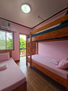 two bunk beds in a room with a window at NOBER Apartments in Puerto Princesa City