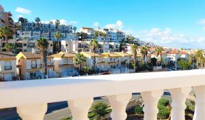 a view of a city with palm trees and buildings at AGAMARI La Mata Torrevieja sun apartment in Torrevieja