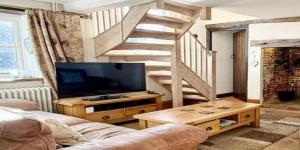 a living room with a staircase and a television at JosepTalaia Villa Top-Class-Villa-Ibiza in Sant Josep
