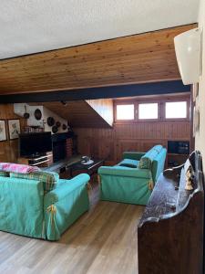 a living room with two couches and a table at Chalet Apartment Gran Zebrù in Oga