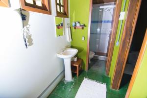 a small bathroom with a sink and a toilet at Cabanas Do Araçá Villa in Porto Belo