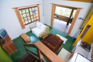 a living room with a couch and a table at Cabanas Do Araçá Villa in Porto Belo