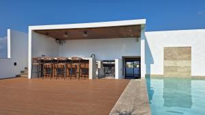 an open patio with chairs and a swimming pool at Playa del Carmen - Playaquerida in Playa del Carmen