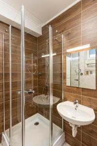 a bathroom with a sink and a shower at Lakeview Apartment Fonyód in Fonyód +38 photos
