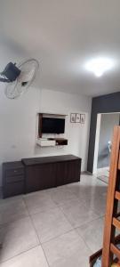 a living room with a flat screen tv on the wall at Araçariguama in Araçariguama