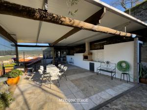 a large patio with a table and chairs on it at Quinta Do Larai in Vale de Cambra