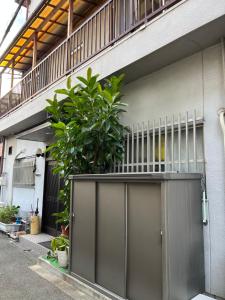 a garage door with a plant on top of it at 6minto Osaka sta Traditional home withJapanese Local in Osaka
