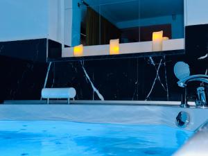 a bathroom with a sink and a mirror at Hedonist Spa Jacuzzi Centar Free private parking in Sarajevo
