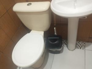 a bathroom with a white toilet and a sink at AP da val 3 no coração de Manaus in Manaus +8 photos