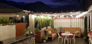 a patio with a table and chairs on a patio at Menacho's House in Caraz