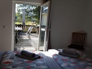 a bedroom with a bed and a sliding glass door at Mill Pond Luxury Escape in Hemschlar